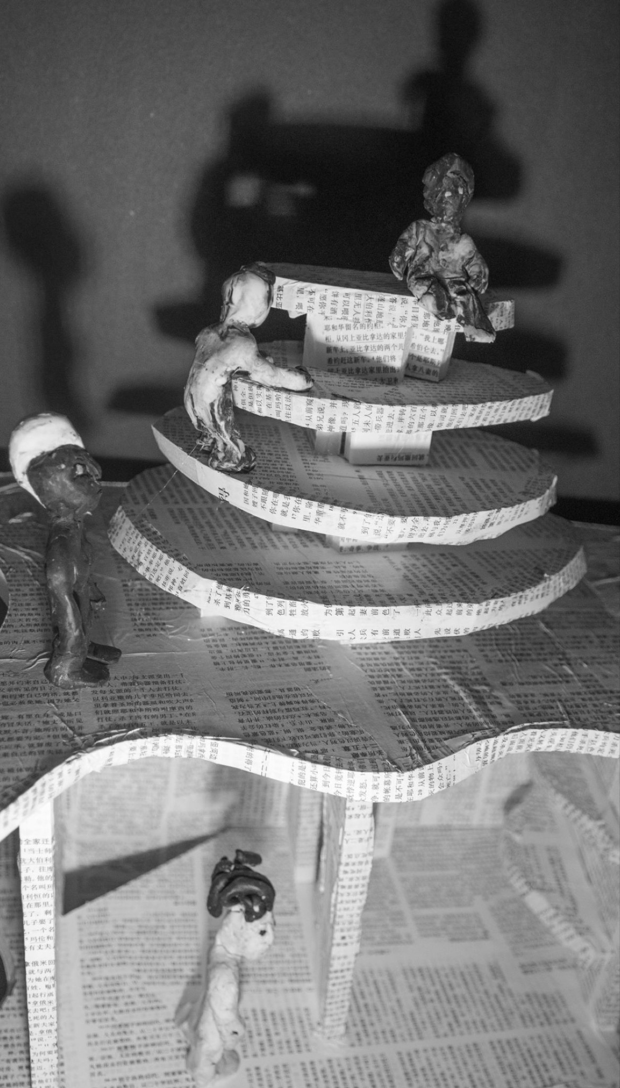 Black and white paper tower with figures