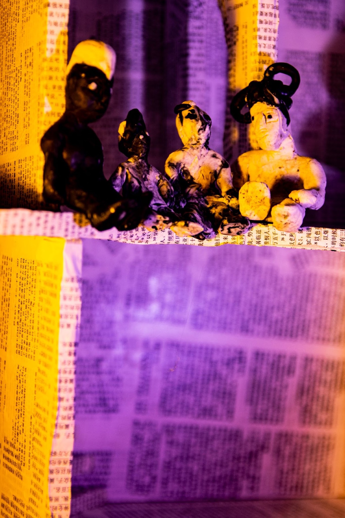 Small handmade family figures in violet paper room