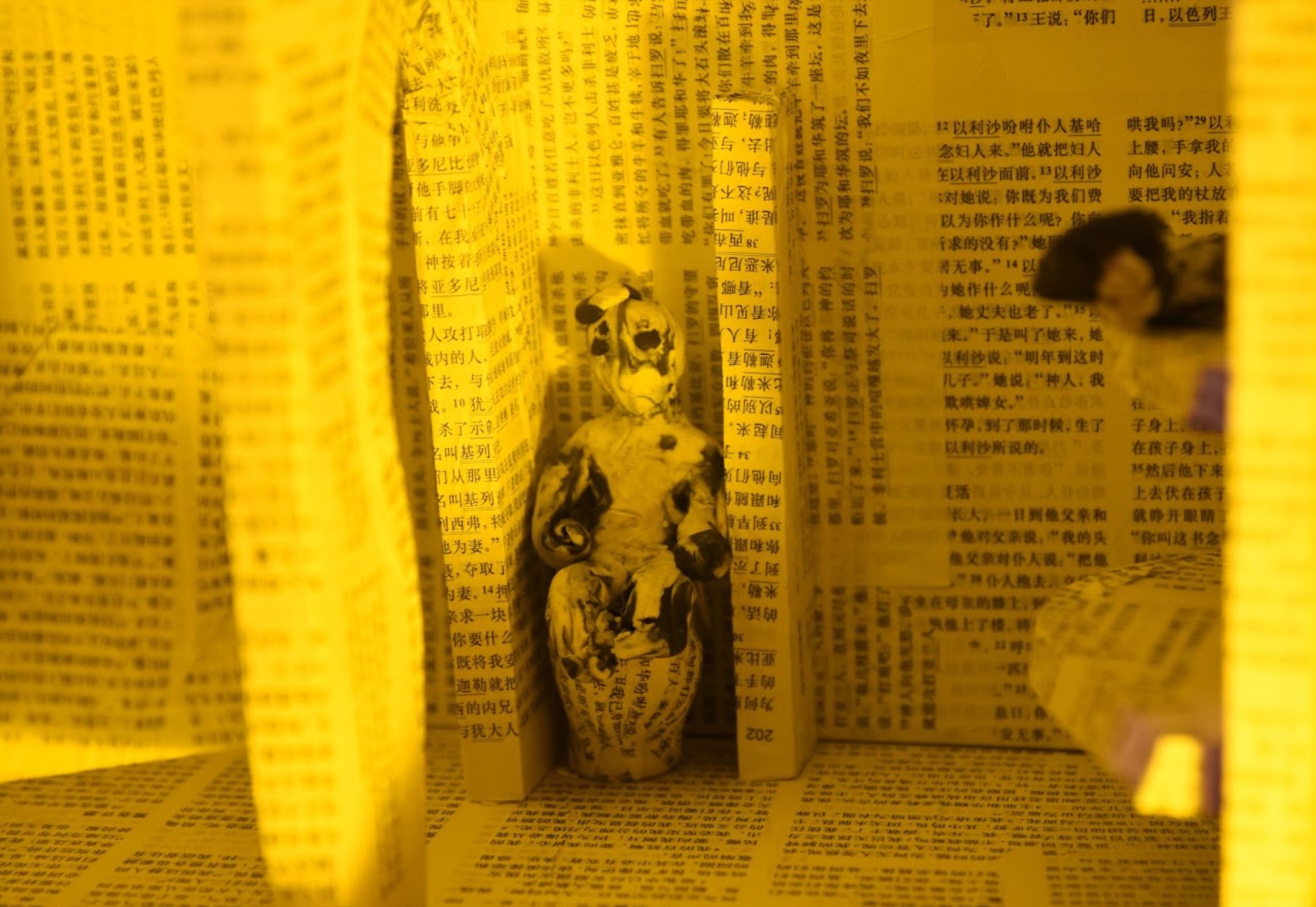 Yellow paper room with seated figure